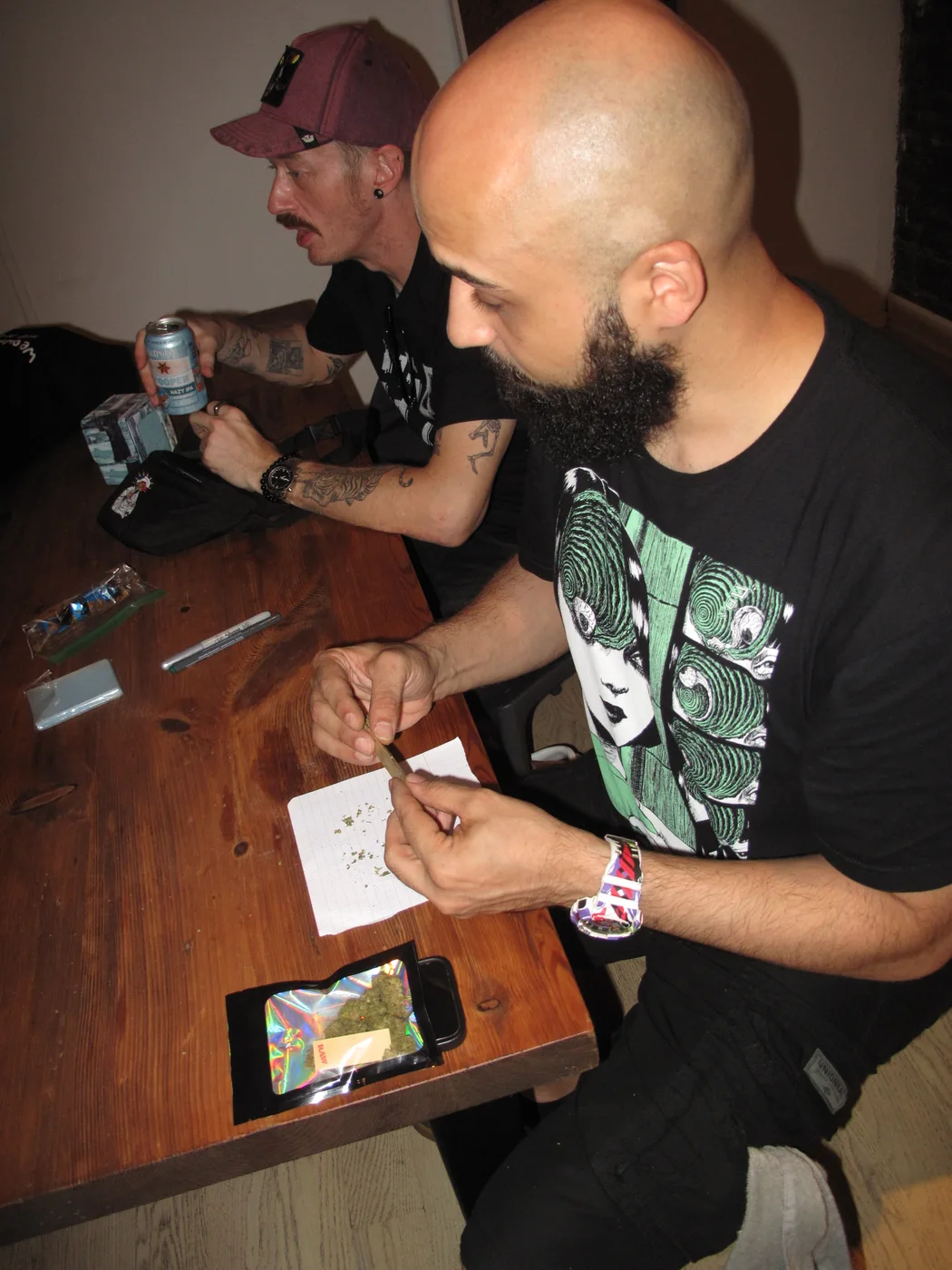 Two guests sitting together at a wooden table during the event